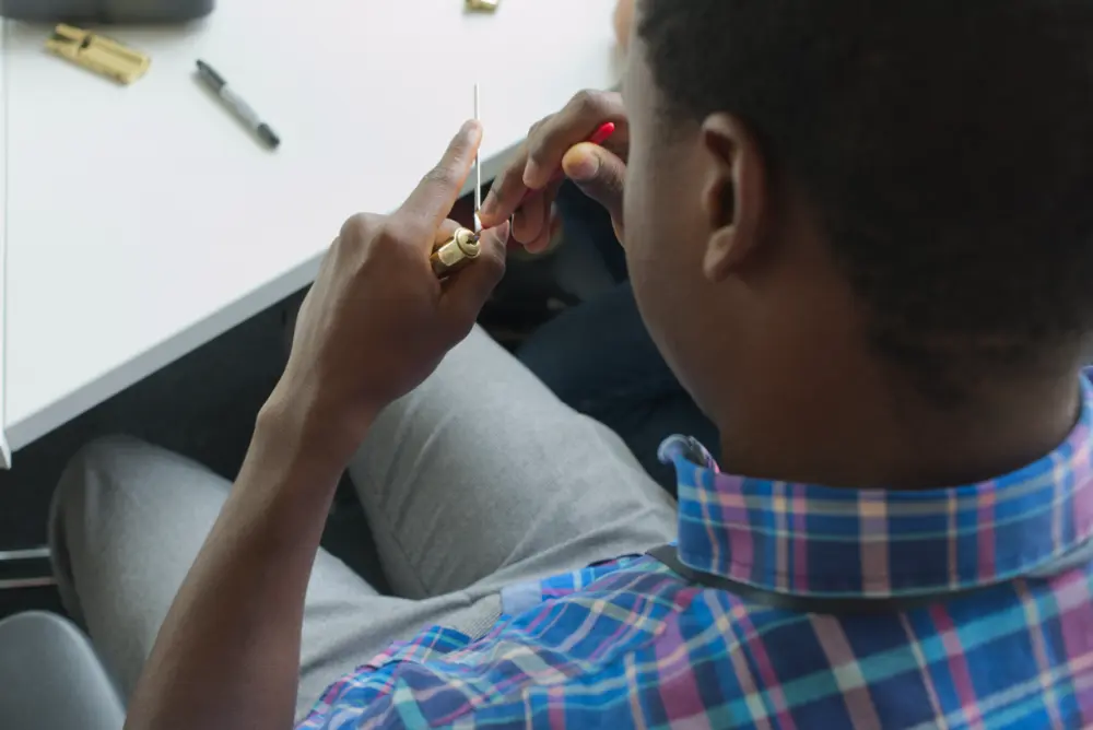 An attendee masters the art of lock picking at Hackademia 2024.